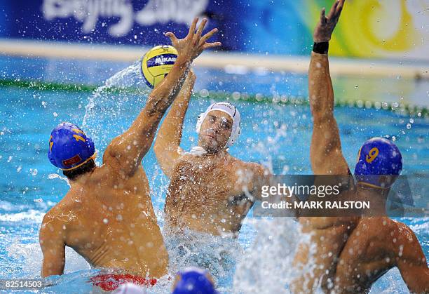Peter Biros from Hungary shoots for goal as Montenegro players attempt to block during their semifinal waterpolo match of the 2008 Beijing Olympics...