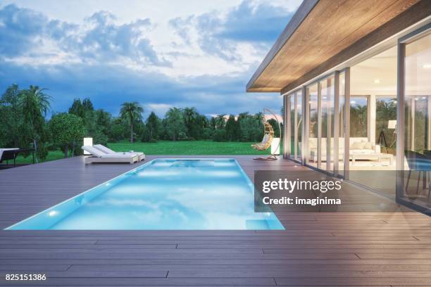 modern luxury house with swimming pool at dawn - modern house dusk stock pictures, royalty-free photos & images