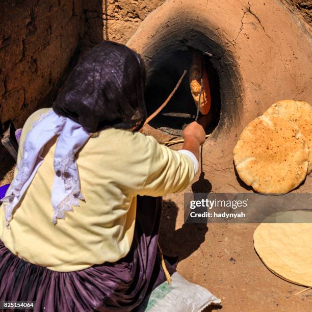 moroccan woman making bread - khubz - tandoor oven stock pictures, royalty-free photos & images