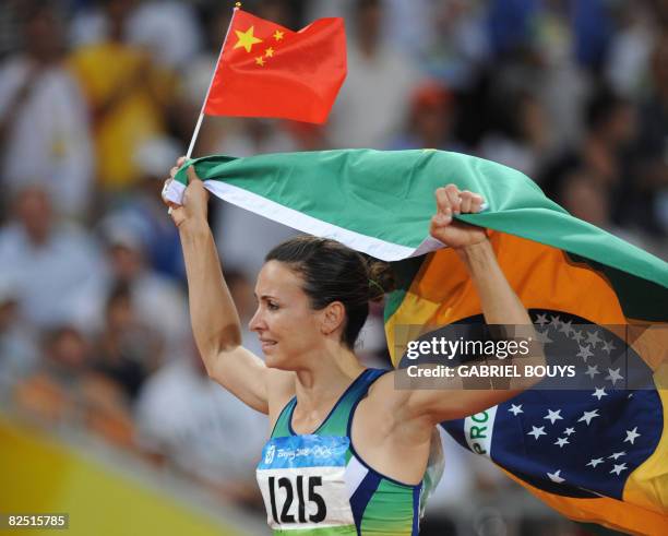 Brazil's Maurren Higa Maggi celebrates after winning the women's long jump final at the "Bird's Nest" National Stadium during the 2008 Beijing...