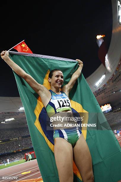 Brazil's Maurren Higa Maggi celebrates after winning the women's long jump final at the "Bird's Nest" National Stadium during the 2008 Beijing...