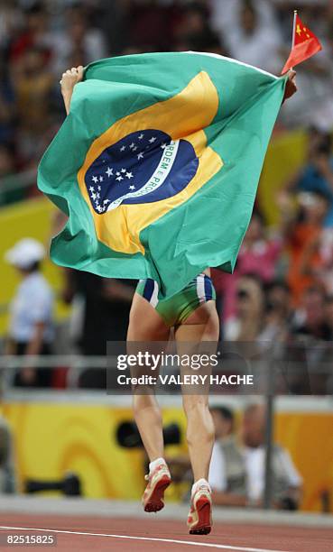 Brazil's Maurren Higa Maggi celebrates winning the women's long jump final at the "Bird's Nest" National Stadium during the 2008 Beijing Olympic...
