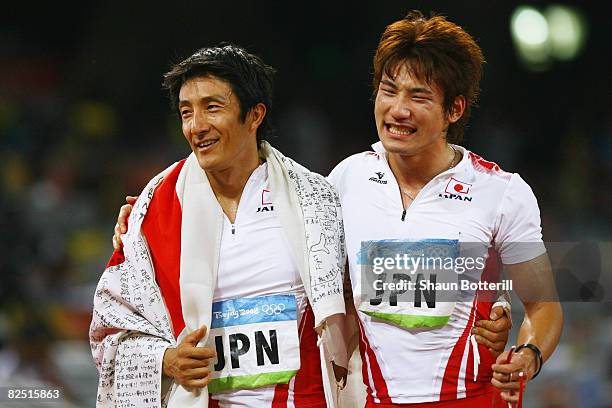 Nobuharu Asahara and Naoki Tsukahara of Japan celebrate following their team's third place finish in the Men's 4 x 100m Relay Final at the National...