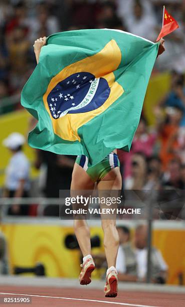 Brazil's Maurren Higa Maggi celebrates winning the women's long jump final at the "Bird's Nest" National Stadium during the 2008 Beijing Olympic...