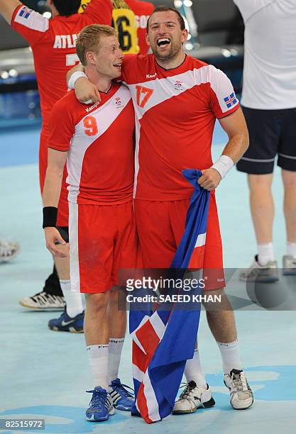 Iceland's Gudjon Valur Sigurdsson and Sverre Andreas Jakobsson celebrate their victory over Spain in a men's handball semifinal of the 2008 Beijing...