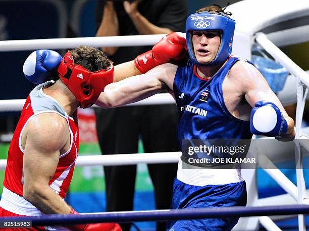 Italy's Roberto Cammarelle fights against Great Britain's David Price during their 2008 Olympic Games Super Heavyweight semifinal boxing bout on...