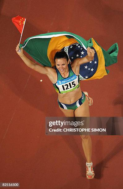 Brazil's Maurren Higa Maggi celebrates after winning the women's Long Jump final at the National Stadium during the 2008 Beijing Olympic Games on...