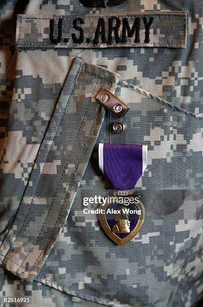 Purple Heart is seen on the uniform of recipient Army Sergeant Russell Mark Broughton II during a Purple Heart presentation ceremony at the Walter...