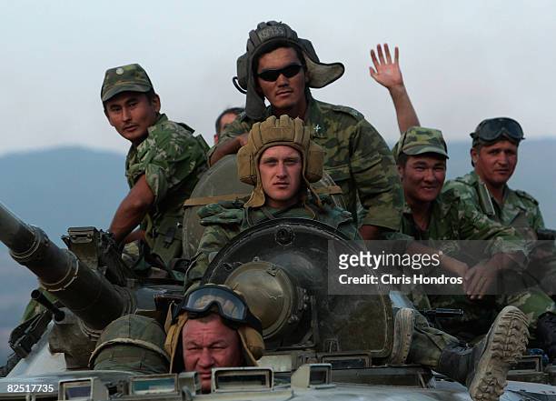 Russian troops sit atop an armored vehicle as they head away from Tbilisi on the main Gori-to-Tbilisi highway August 22, 2008 outside of Gori,...