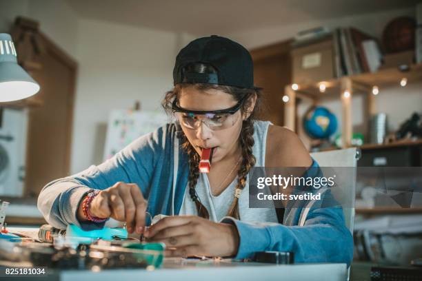 Teenage girl experimenting with electronics