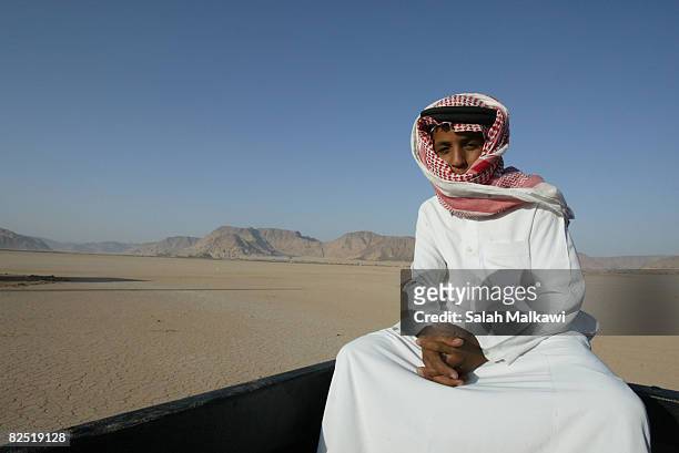 Jordanian bedouin child sits on a truck during a camel race in the desert of Wadi Rum, on August 22, 2008 in Jordan. Jordanian and Saudi bedouins...