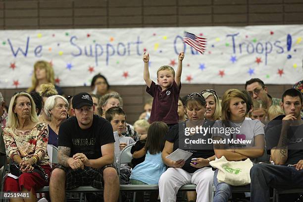 Three-year-old Ryan O'Mara waves a flag for his uncle Major Kris Kough during a farewell ceremony for about 850 California National Guardsmen from...