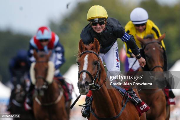 Andrea Atzeni celebrates after riding Stradivarius to win The Qatar Goodwood Cup series from Big Orange on day one of the Qatar Goodwood Festival at...