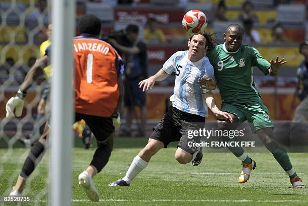 Argentinian forward Lionel Messi and Nigerian forward Victor Obinna fight for the ball in front of Nigerian goalkeeper Ambruse Vanzekin during the...