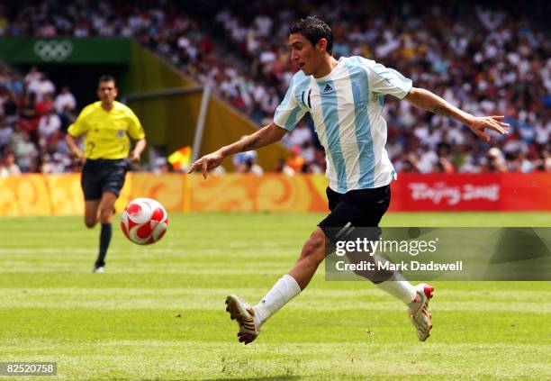 Angel Di Maria of Argentina chips in for the opening goal in the Men's Gold Medal football match between Nigeria and Argentina at the National...