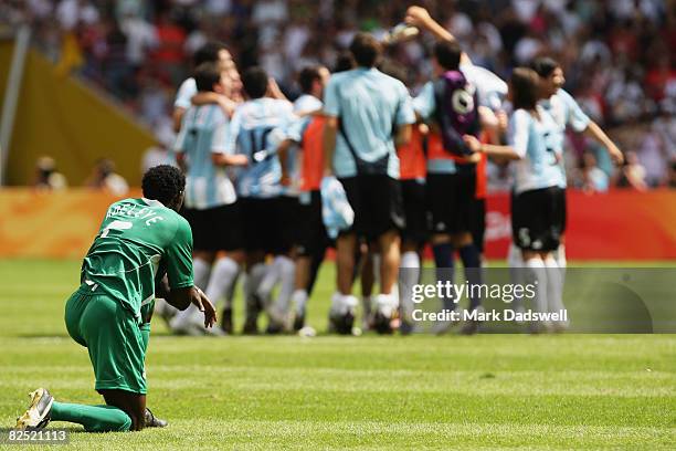 Argentina celebrate winning the Men's Gold Medal football match between Nigeria and Argentina as Dele Adeleye of Nigeria looks on at the National...