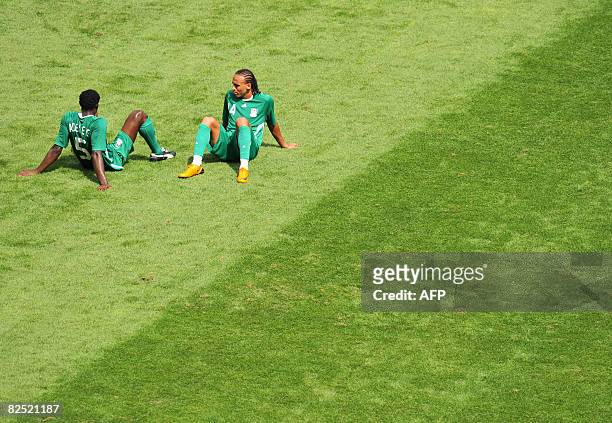 Nigerian defender Dele Adeleye and forward teammate Peter Odemwingie look dejected after Argentina won the men's Olympic football final over Nigeria...