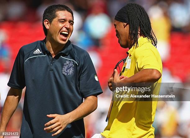 Juan Riquelme of Argentina and Ronaldinho of Brazil share a joke during the medal ceremony for the Men's Football at the National Stadium on Day 15...
