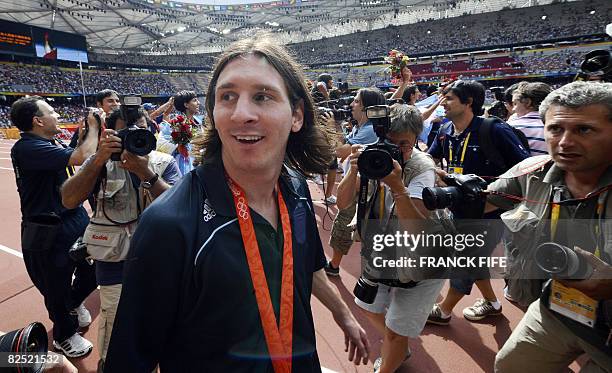 Argentinian forward Lionel Messi leaves the pitch with his gold medal after attending the men's Olympic football tournament medal ceremony at the...