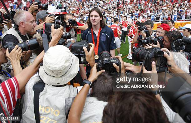 Argentinian forward Lionel Messi poses for photographers during the men's Olympic football tournament medal ceremony at the national stadium in...