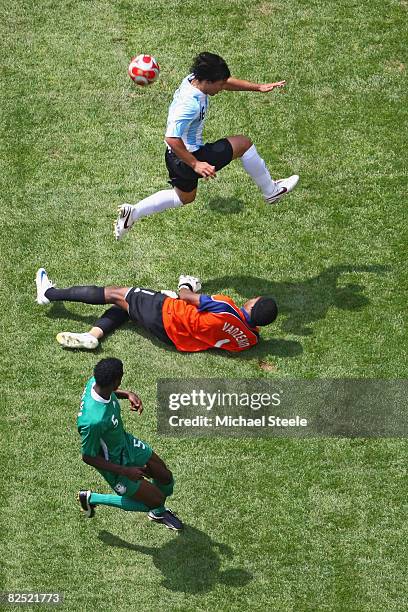 Sergio Aguero of Argentina jumps goalkeeper Ambrose Vanzekin of Nigeria in the Men's Gold Medal football match between Nigeria and Argentina at the...