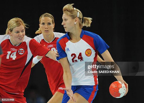 Russia's Irina Bliznova is marked by Norway's Tonje Larsen and Gro Hammerseng during the women's handball gold medal match of the 2008 Beijing...
