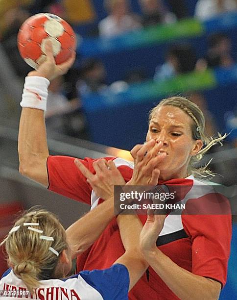 Norway's Gro Hammerseng is marked by Russia's Ekaterina Andryushina during the women's handball gold medal match of the 2008 Beijing Olympic Games on...
