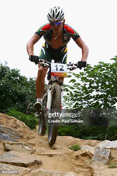 Burry Stander of South Africa competes in the Men's Cross Country mountain bike cycling event held at the Laoshan Mountain Bike Course on Day 15 of...