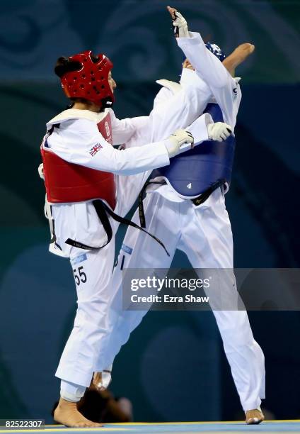 Sarah Stevenson of Great Britain kicks Zhong Chen of China in the Women's +67kg Quarterfinals at the University of Science and Technology Beijing...