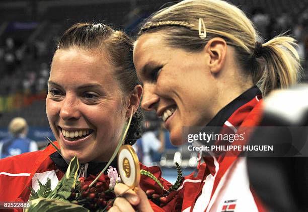 Gro Hammerseng and Else Marthe Soerlie Lybekk, of the women handball team of Norway, pose for pictures after receiving the gold medal in the 2008...