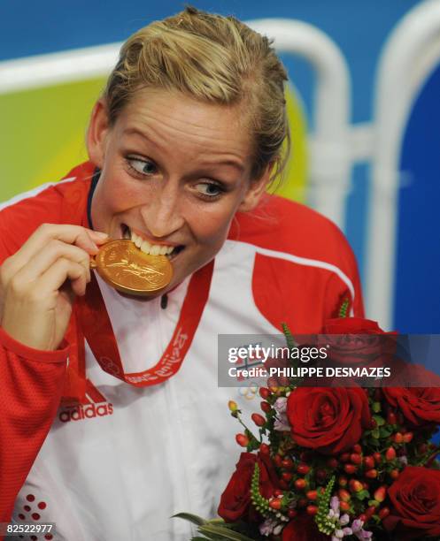 Gro Hammerseng, of the women handball team of Norway, poses for photographers after receiving the gold medal in the 2008 Beijing Olympic Games on...