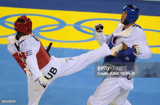 Angel Valodia Matos of Cuba lands a kick on Liu Xiaobo of China in the quarterfinal of the men's +80 kg taekwondo competition during the 2008 Beijing...