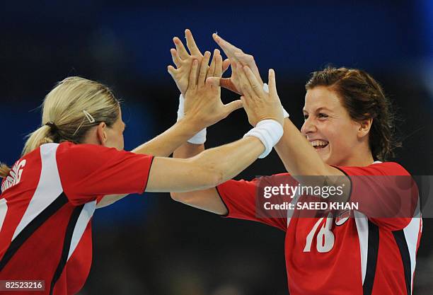 Norway's Gro Hammerseng and Linn-Kristin Riegelhuth celebrate after scoring against Russia during the women's handball gold medal match of the 2008...