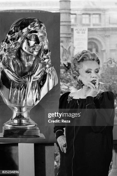 French actress, Jeanne Moreau next to the poster of the Nuit des Molière on May 10, 1989.