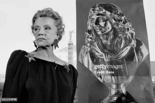 French actress, Jeanne Moreau next to the poster of the Nuit des Molière on May 10, 1989.