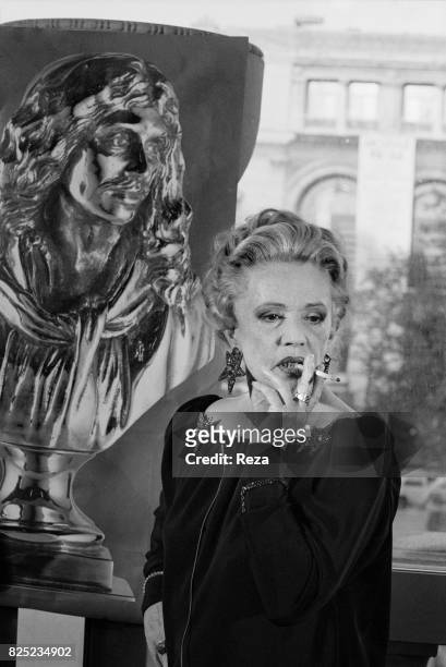 French actress, Jeanne Moreau next to the poster of the Nuit des Molière on May 10, 1989.