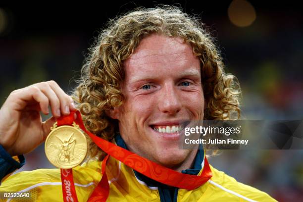 Steve Hooker of Australia receives the gold medal during the medal ceremony for the Men's Pole Vault Final held at the National Stadium on Day 15 of...