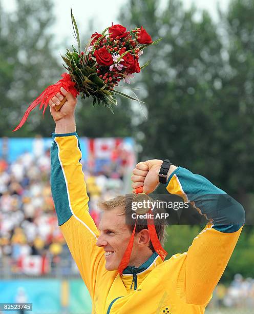 Autralia's Ken Wallace shows his gold medal during the medals ceremony after winning the men's kayak double K2 flatwater finals in the 2008 Beijing...