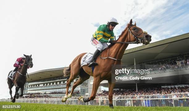 Galway , Ireland - 1 August 2017; Housesofparliament, with Barry Geraghty up, cross the line to win the Colm Quinn BMW Novice Hurdle ahead of Morgan,...