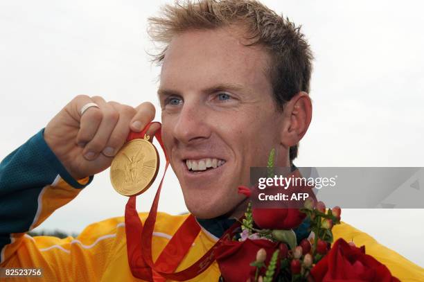 Autralia's Ken Wallace shows his gold medal following the medals ceremony after winning the men's kayak double K2 flatwater finals in the 2008...