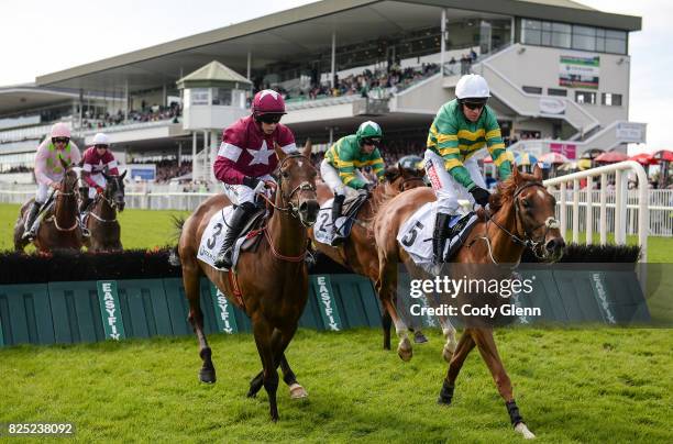 Galway , Ireland - 1 August 2017; Eventual winner Housesofparliament, right, with Barry Geraghty up, jump the fifth alongside Cinema De Quartier,...