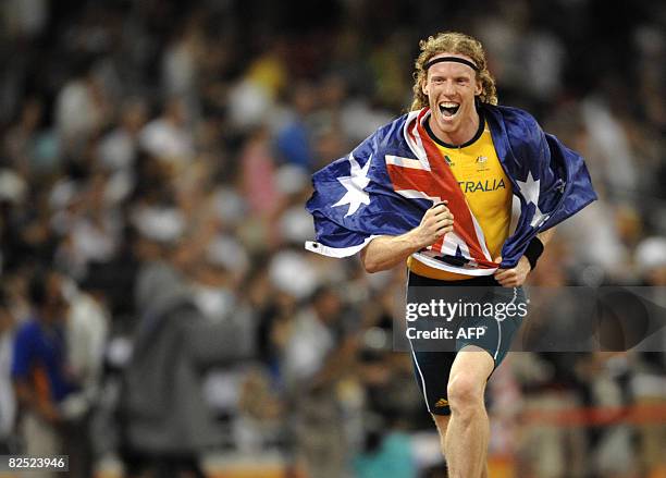 Australia's Steve Hooker celebrates during the men's pole vault medal ceremony at the "Bird's Nest" National Stadium during the 2008 Beijing Olympic...