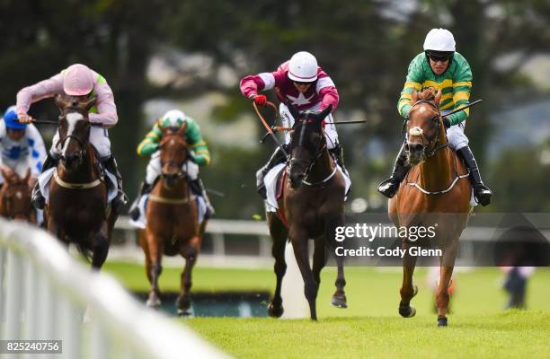 Galway , Ireland - 1 August 2017; Eventual winner Housesofparliament, right, with Barry Geraghty up, race ahead of Morgan, centre, with Keith...