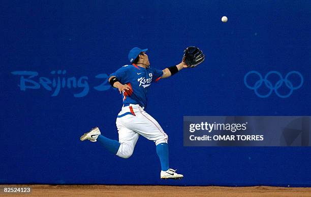 South Korea's leftfielder Kim Hyun-soo fails to catch a double off Cuban batter Alfredo Despaigne in the fifth inning of the men's baseball final at...