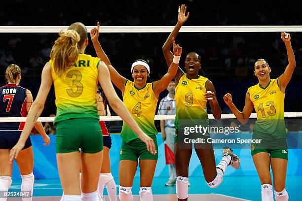 Paula Pequeno, Fabiana Claudino and Sheilla Castro of Brazil celebrate during the women's gold medal volleyball game held at the Beijing Institute of...