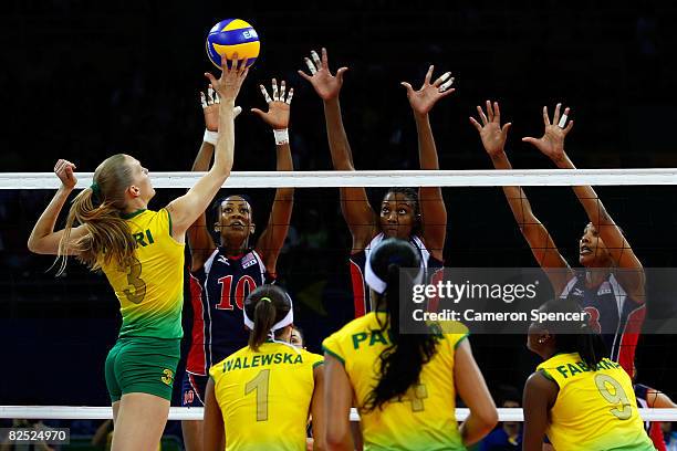Marianne Steinbrecher of Brazil tries to spike the ball past Kim Glass, Danielle Scott-Arruda and Heather Bown of the United States during the...
