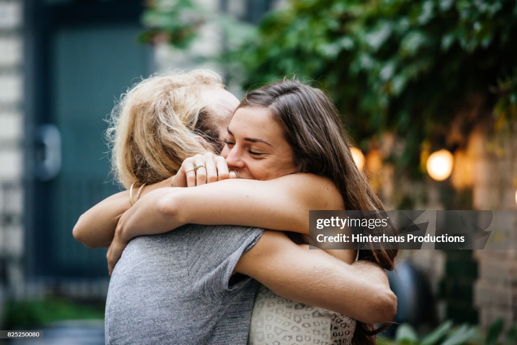 Young Couple Embrace Each Other Lovingly At Barbecue Meetup