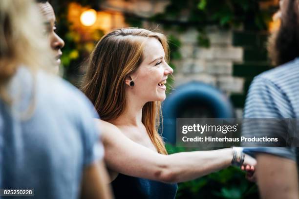 a young group of friends meeting up for a barbecue - greeting friends stock pictures, royalty-free photos & images