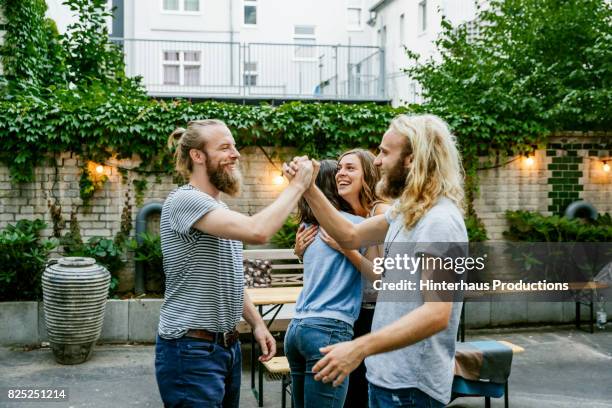 two young guys pleased to see each other at barbecue meetup with friends - german greens party stock pictures, royalty-free photos & images