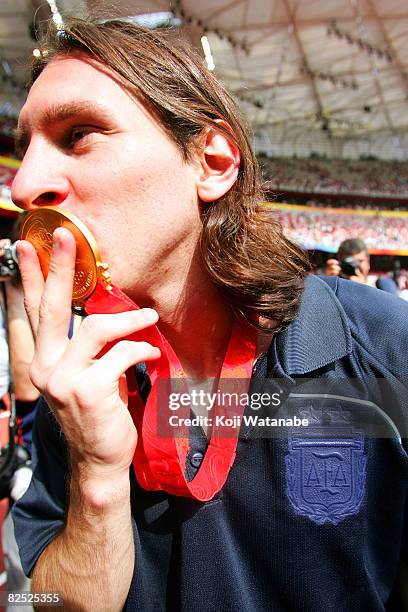 Argentinian forward Lionel Messi kisses his gold medal as he leaves the pitch after attending the Men's Final between Nigeria and Argentina at the...